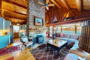 a living room with a couch and a fireplace at Riverfront retreat with a furnished deck, washer/dryer & fast WiFi in Boothbay