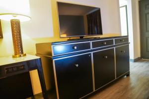 a large dresser with a television on top of it at Horizon Inn Norcross in Norcross