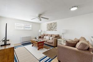 a living room with two couches and a tv at Well-located, dog-friendly home - walk to footbridge & Barrett Park in Boothbay Harbor