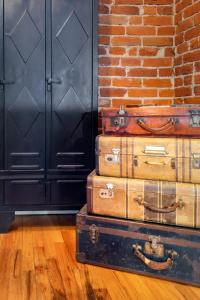a stack of suitcases sitting next to a brick wall at The Whittier Wonder in Denver +45 photos