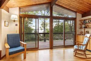 a living room with a sliding glass door at Beautiful hidden Waterfront Retreat with Rocky Beach in Boothbay