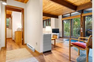 a living room with a desk and a chair at Beautiful hidden Waterfront Retreat with Rocky Beach in Boothbay