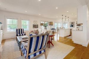 a living room with a couch and a table at Elegant home with veranda & water view, walk to downtown Boothbay Harbor in Boothbay Harbor