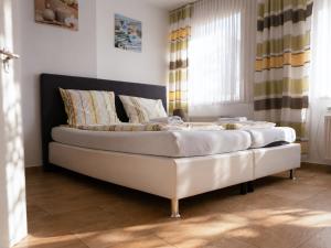 a large white couch in a room with a window at Hotel Restaurant Neffelthal in Kerpen +12 photos