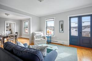 a living room with a couch and a table at Waterfront, walkable, updated home with harbor views & partial AC in Camden