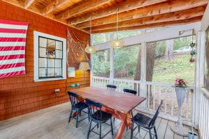 a dining room with a wooden table and chairs at Cozy, Waterfront Cabin-Style Gem with Private Dock and Lovely Views in East Harpswell +28 photos