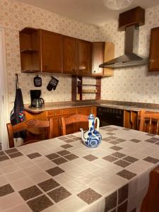 a kitchen with a table with a blue vase on it at Casita San Simon in Bayón +10 photos