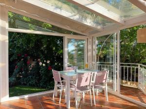 a screened in porch with a table and chairs at La Casita de Numancia in Garray