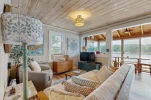 a living room with a couch and a television at Charming Oceanfront Home with Stunning Water Views and Wifi in Georgetown