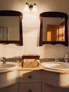a bathroom with two sinks and two mirrors at La Casita de Numancia in Garray +15 photos
