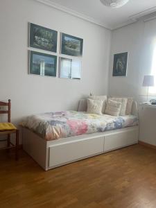 a white bedroom with a bed in a room at La Casita de Numancia in Garray