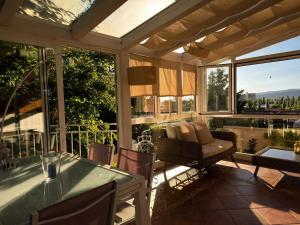 a screened in porch with a table and chairs at La Casita de Numancia in Garray