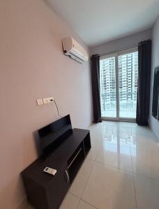 a room with a black desk and a large window at The Lake view Timber House in Hyderabad