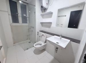 a white bathroom with a toilet and a sink at The Lake view Timber House in Hyderabad +14 photos