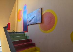 a stairway with a painting on the wall and a painting at Sea promenade Hostel Art Apartment in El Mîna