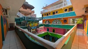a hammock in the middle of a building at Aruma Stays in Brisas de Zicatela