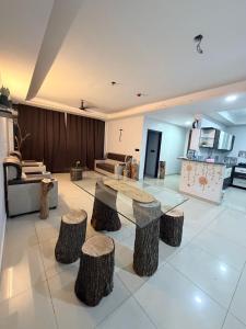 a living room with a table and tree stump stools at The Lake view Timber House in Hyderabad