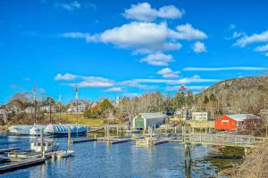 a marina on a river with a red house at Waterfront Duplex, walkable, harbor views, AC, dog friendly in Camden