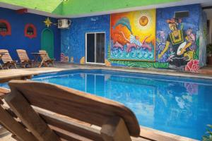a large swimming pool with a mural on the wall at Aruma Stays in Brisas de Zicatela +67 photos