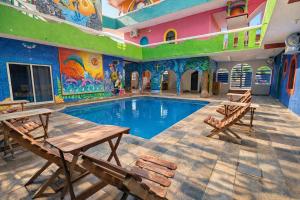 a pool in a building with a painting on the wall at Aruma Stays in Brisas de Zicatela