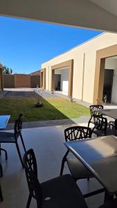 a group of tables and chairs on a patio at Pousada Vila dos Anjos in Chapada dos Guimarães