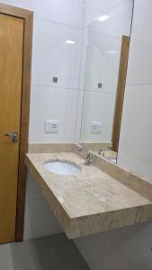 a bathroom counter with a sink and a mirror at Pousada Vila dos Anjos in Chapada dos Guimarães +13 photos