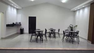 a group of tables and chairs in a room at Pousada Vila dos Anjos in Chapada dos Guimarães