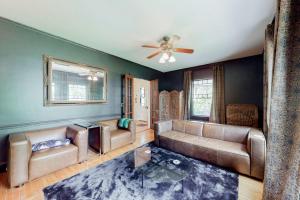 a living room with couches and a ceiling fan at Beautiful home with Ping-Pong, fast WiFi & W/D - walk to dining in Wiscasset