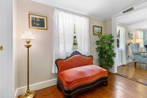 a living room with a chair and a window at Dog-friendly oceanfront home with private shorefront, two fireplaces, & firepit in Steuben