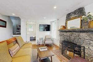 a living room with a couch and a fireplace at Coastal charmer with screened-in porch, grill, & AC in Boothbay Harbor