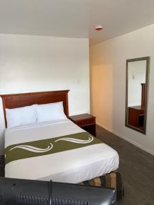a bedroom with a bed and a mirror at Royal Motel in Allentown