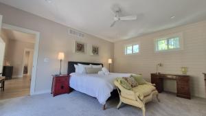 a bedroom with a large bed and a chair at Prairie View in Sawyer