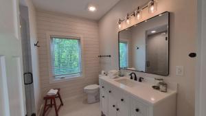 a white bathroom with a sink and a mirror at Prairie View in Sawyer +34 photos