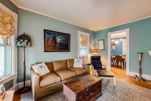 a living room with a couch and a table at Dog-friendly historical home with recent updates, porch & prime in-town location in Rockland
