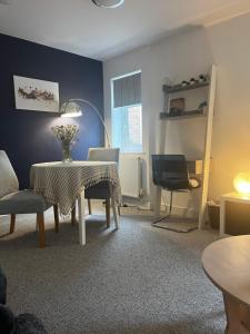 a living room with a table and a chair at Westerleigh Annexe - Self-contained accommodation in Langport