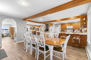 a kitchen and dining room with a table and chairs at Cobbossee Hideaway, lakefront property with dock for swimming, fishing, and sunrises in Winthrop