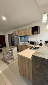 a large kitchen with wooden cabinets and a counter top at Departamento moderno en Durango in Durango