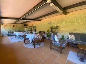 a dining room with tables and chairs and a piano at Casa Do Conde in Caldas de Reis