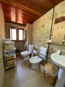 a bathroom with two toilets and a sink at Casa Do Conde in Caldas de Reis +76 photos