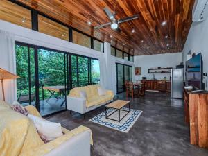 a living room with a couch and a table at Samara by the River Vacation Suites in Sámara