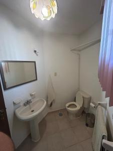 a bathroom with a sink and a toilet and a mirror at Casa Corazón de Boca, steps from the beach and restaurants in Boca del Río +66 photos