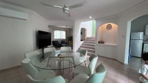 a living room with a glass table and chairs at Casa Corazón de Boca, steps from the beach and restaurants in Boca del Río