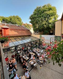 an overhead view of a crowd of people sitting at tables at Quasi Rooms in Eger