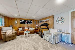 a living room with several chairs and a couch at Oceanfront home with dock, beautiful deck & firepit - steps to the beach in Harpswell Center