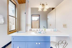 a bathroom with a blue sink and a mirror at Private Oceanfront Home -- 2 Fireplaces, 4 Decks & Grill, Dog-friendly in East Boothbay +41 photos