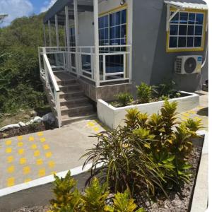 a house with stairs and plants in front of it at Posada MaiMai in Providencia