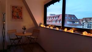 a room with a table and a window with candles at Appartement L'esprit marin in Villers-sur-Mer