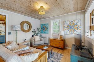 a living room with a couch and a tv at Charming Oceanfront Home with Stunning Water Views and Wifi in Georgetown