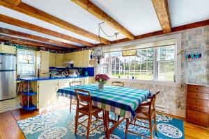 a kitchen with a table with a blue and white table cloth at Charming Seaside Cottage with a Gas Fireplace, Spacious Patio, and Nearby Hiking in Hancock