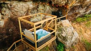 an overhead view of a bath tub in a cave at Cliff Hot Tub with Deck Fire Pit Mural and Pet Friendly in Rogers